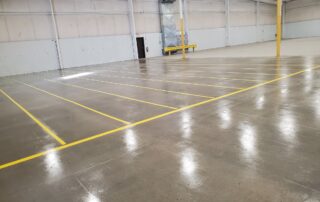 epoxy stripped flooring in a warehouse done with diamond grinding and shot blasting