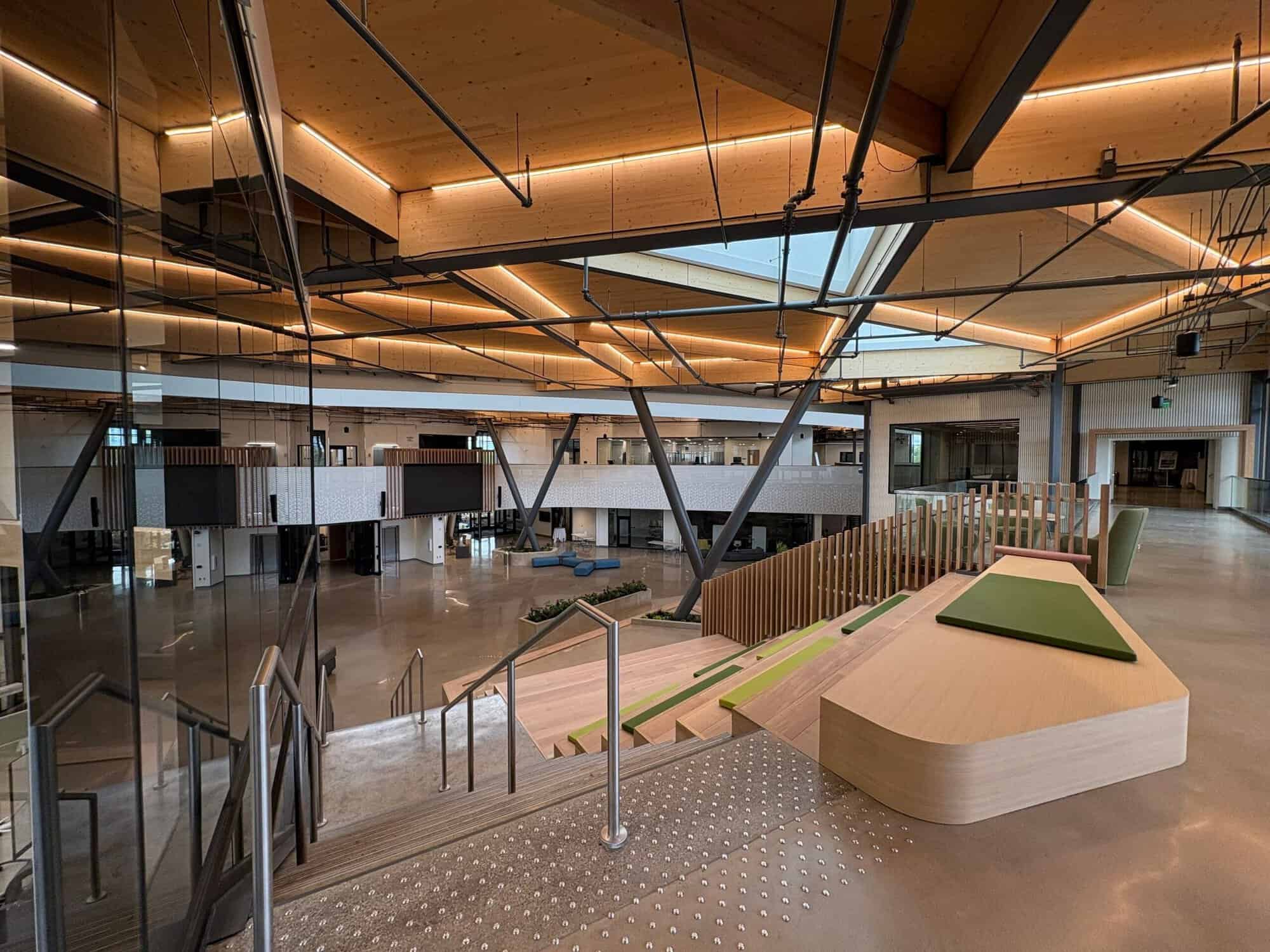 KRESA (6) Open commons and feature stair at the KRESA Career Connect Campus with mass timber ceiling, coated steel framing, and polished floor coating
