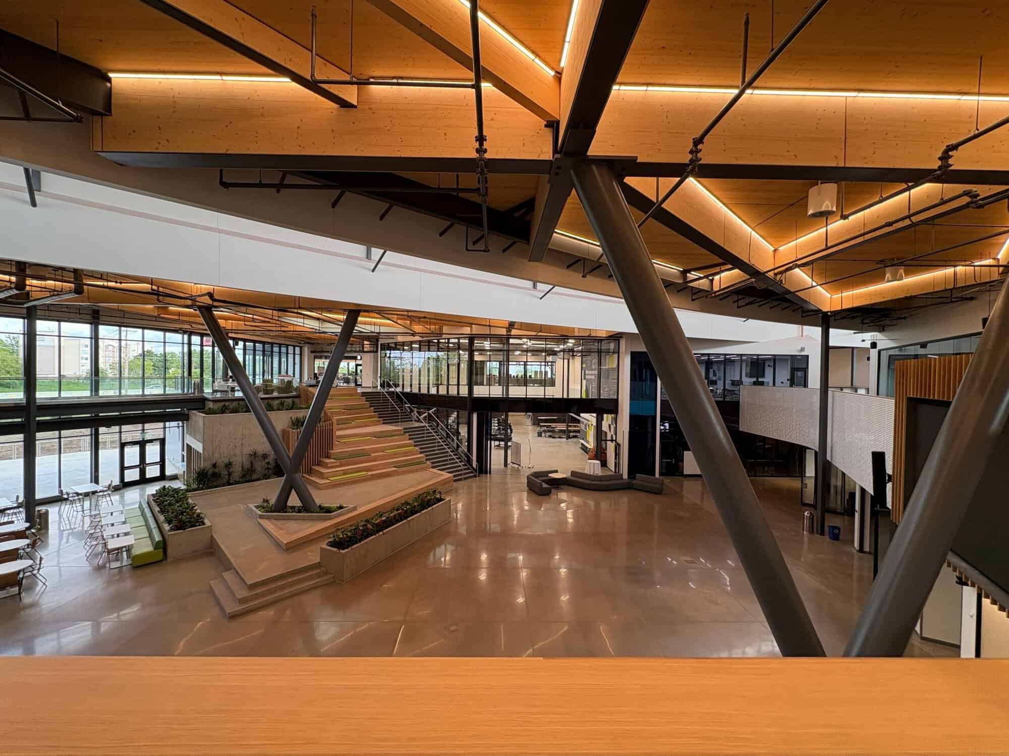 KRESA (7) Commons at the KRESA Career Connect Campus viewed from the second level, with coated structural steel columns and mass timber ceiling by H&H Painting