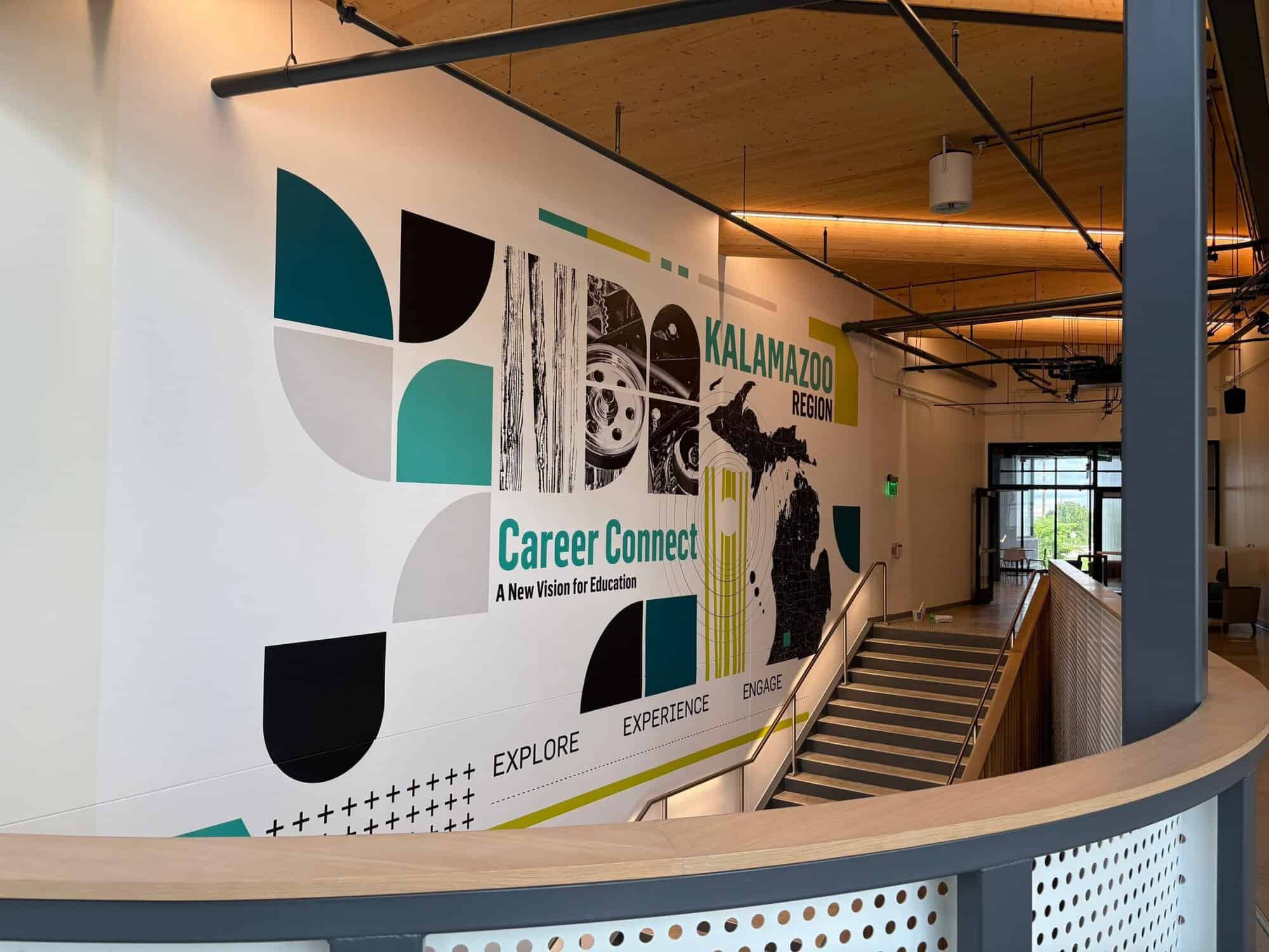 Career Connect Commercial Wall Mural White-painted commercial interior wall with teal, black, yellow geometric graphics and Career Connect Kalamazoo branding.