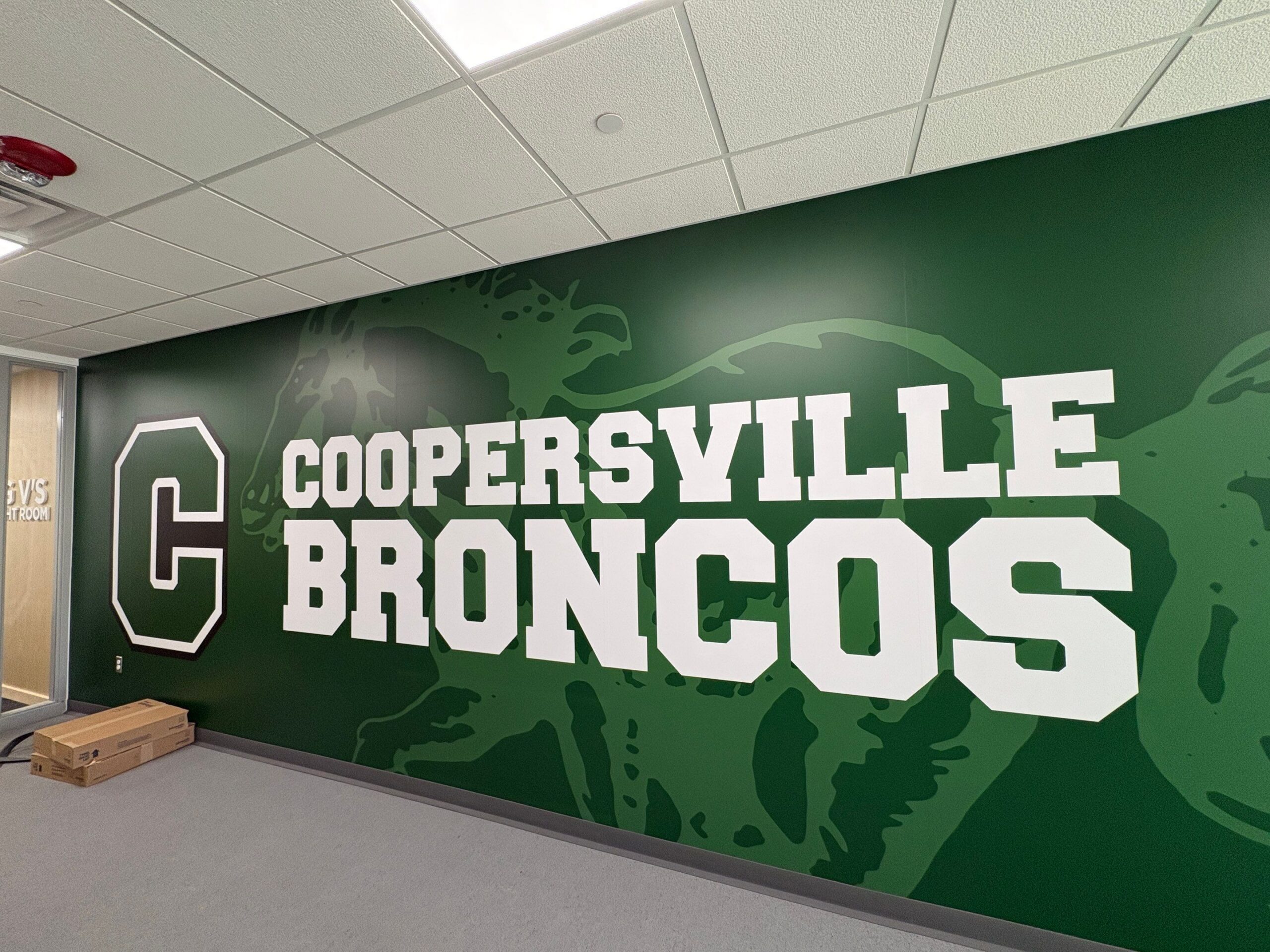 Coopersville Broncos School Wall Mural Painting Large green wall mural featuring Coopersville Broncos logo and text for a school or commercial space.
